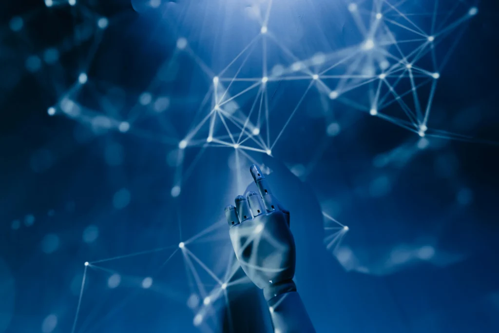 Robotic hand reaching toward a blue network of interconnected glowing nodes and lines.