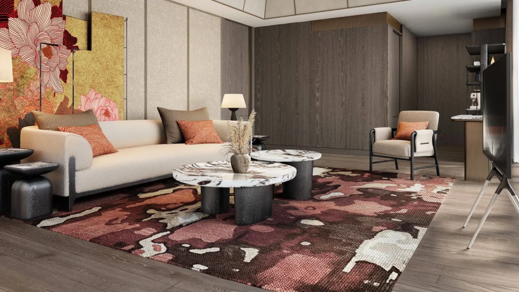 Modern living room with a beige sofa, orange cushions, and two round marble coffee tables on a red patterned rug.